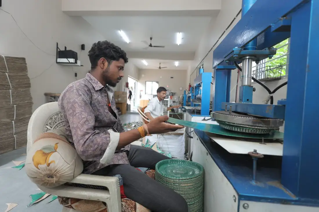 Leaf print paper dishes being pressed and stacked